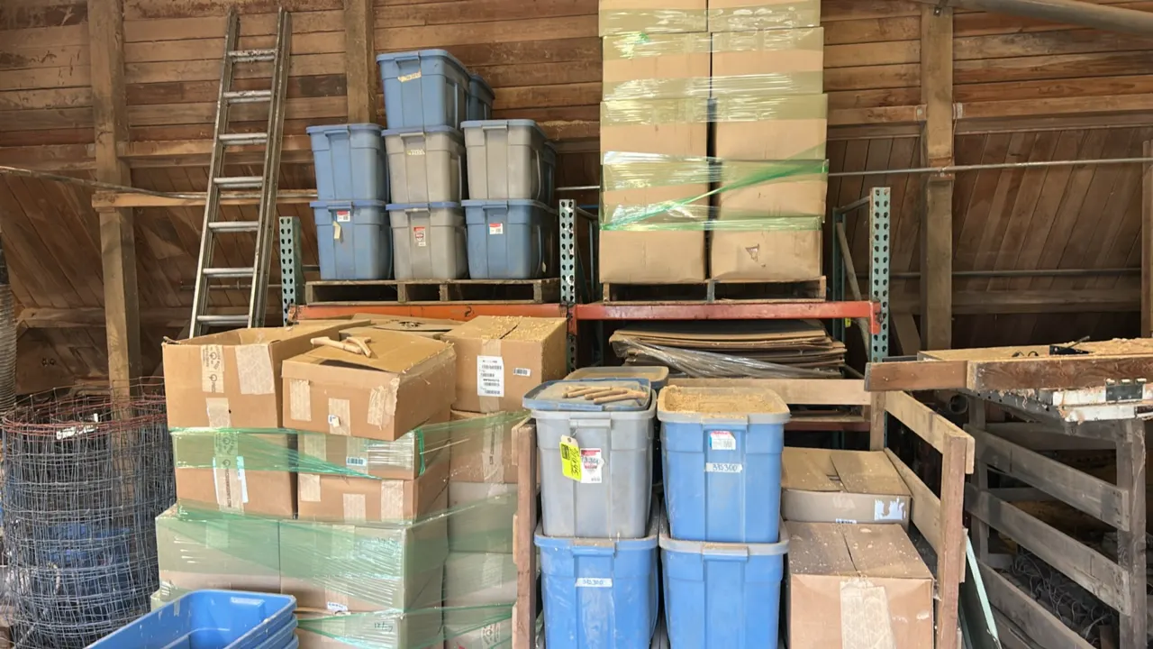 Metal teardrop pallet racking. Features green upright frames and orange cross beams. 48" x 44" x 72". Contents not included.
