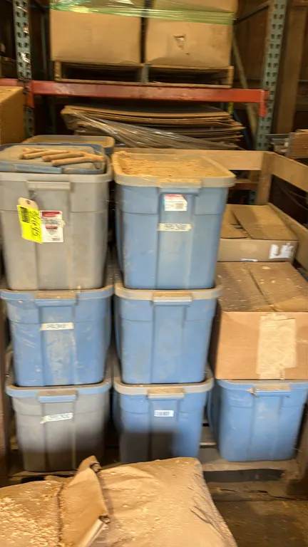 Assorted lot of unfinished wood paint brush handles. Features pre-drilled hang holes. Packaged across multiple plastic storage totes and cardboard box