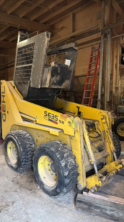 Gehl SL5635 wheeled skid steer loader. Powered by a diesel engine. Features auxiliary hydraulics and includes a 6' bucket. Hour meter shows 4,310 hour