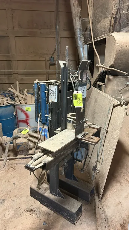 Pneumatic drill press fixture. Features dual air cylinders, vertical tooling guides, adjustable stops, and fabricated steel pedestal base. Note: Unit