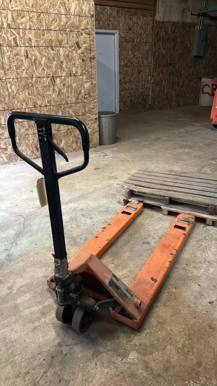 Haul-Master manual pallet jack. Features a 5,000 lb load capacity and a 3-position hand control lever for lift, neutral, and lower operation. S/N: 379