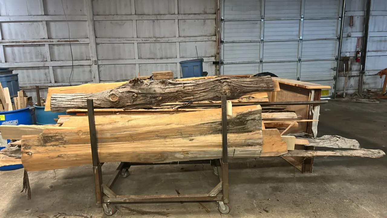 Metal lumber rack with assorted cedar lumber. Includes a quantity of assorted cedar planks and live edge cedar boards. Rack dimensions: 50" x 40". Mou