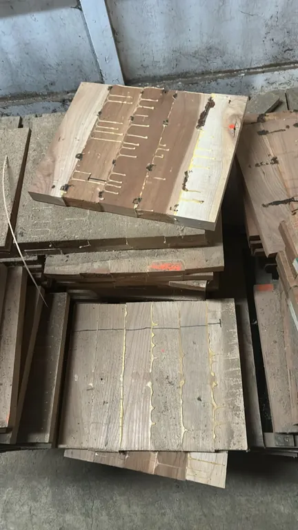 Pallets of assorted wood butcher blocks. Features laminated solid wood construction with assorted sizes and thicknesses. Stacked on wooden pallets.