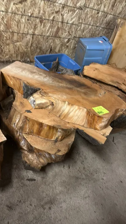 Cedar live edge cross-cut tree slabs. Features natural edge profiles and visible growth rings. Approx. assorted diameter and varying thickness.