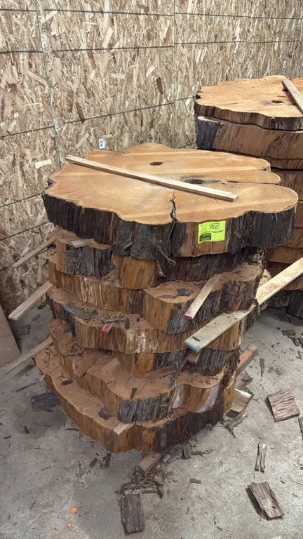 Cedar live edge cross-cut tree slabs. Features natural bark edges. Approximately 45" diameter x 5.5" thick.