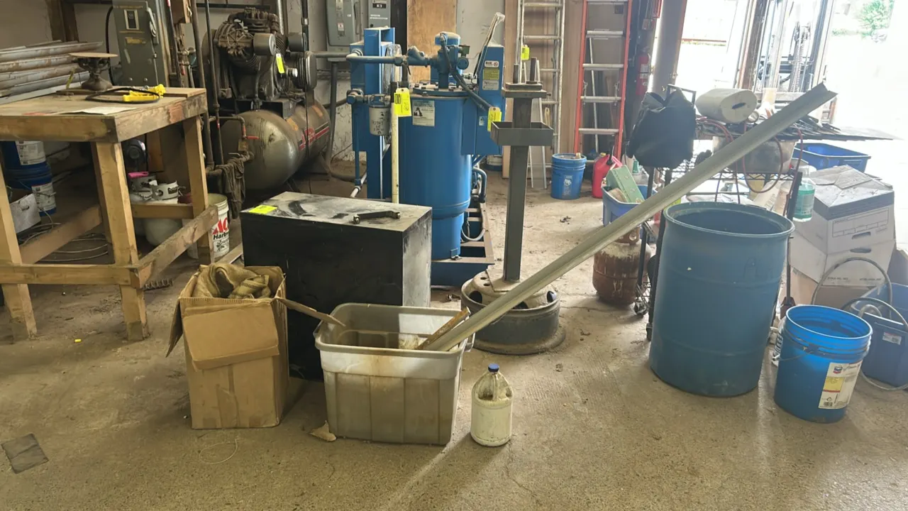 Package lot including a 2-drawer metal filing cabinet, a box with burlap sack and burlap strapping, and a plastic tote containing assorted metal parts