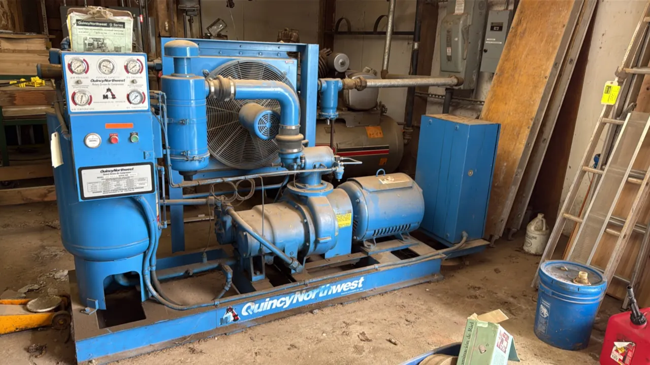 Quincy Northwest QNW-242-D-A rotary screw air compressor. Features analog gauge panel, cooling fan assembly, and Siemens control box. Shows 91,467 hou