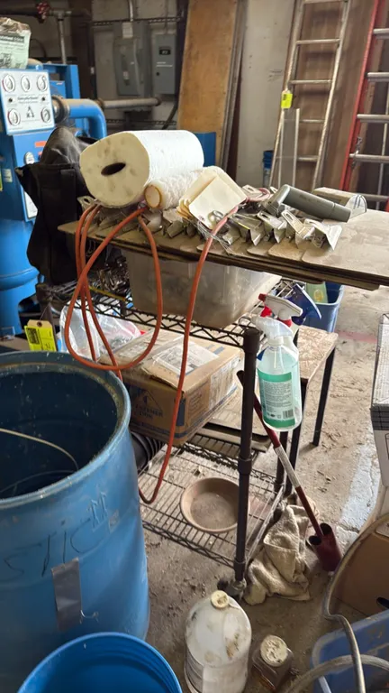 Portable wire utility cart. Includes assorted clipboards, boxed supplies, and miscellaneous items. 2'L. Mounted on casters.