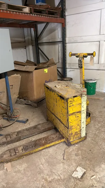 Yale electric walkie pallet jack. Features dual forks and control handle with forward and reverse throttle levers and lift/lower push buttons. Note: U