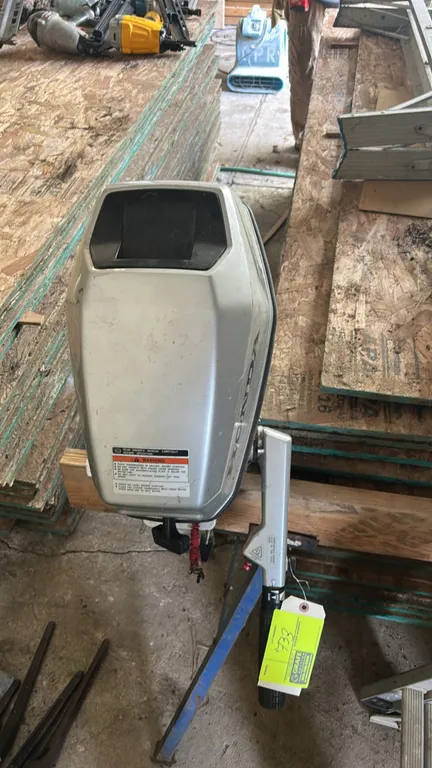Honda 5 HP 4-stroke portable outboard motor. Features tiller handle throttle control, manual recoil start, Programmed Ignition, and 3-blade propeller.