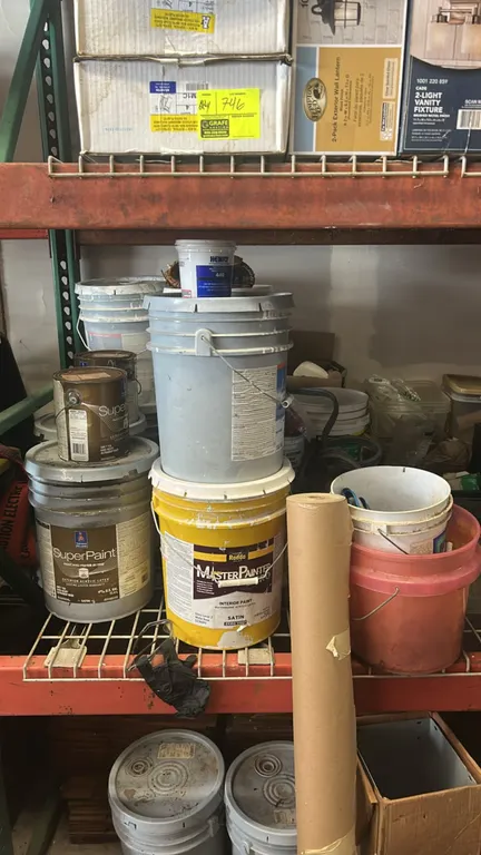 Assorted paint, primer, conduit, and maintenance supplies lot. Includes 5-gallon and 1-gallon paint buckets (Sherwin-Williams, Rodda), Henry adhesive,