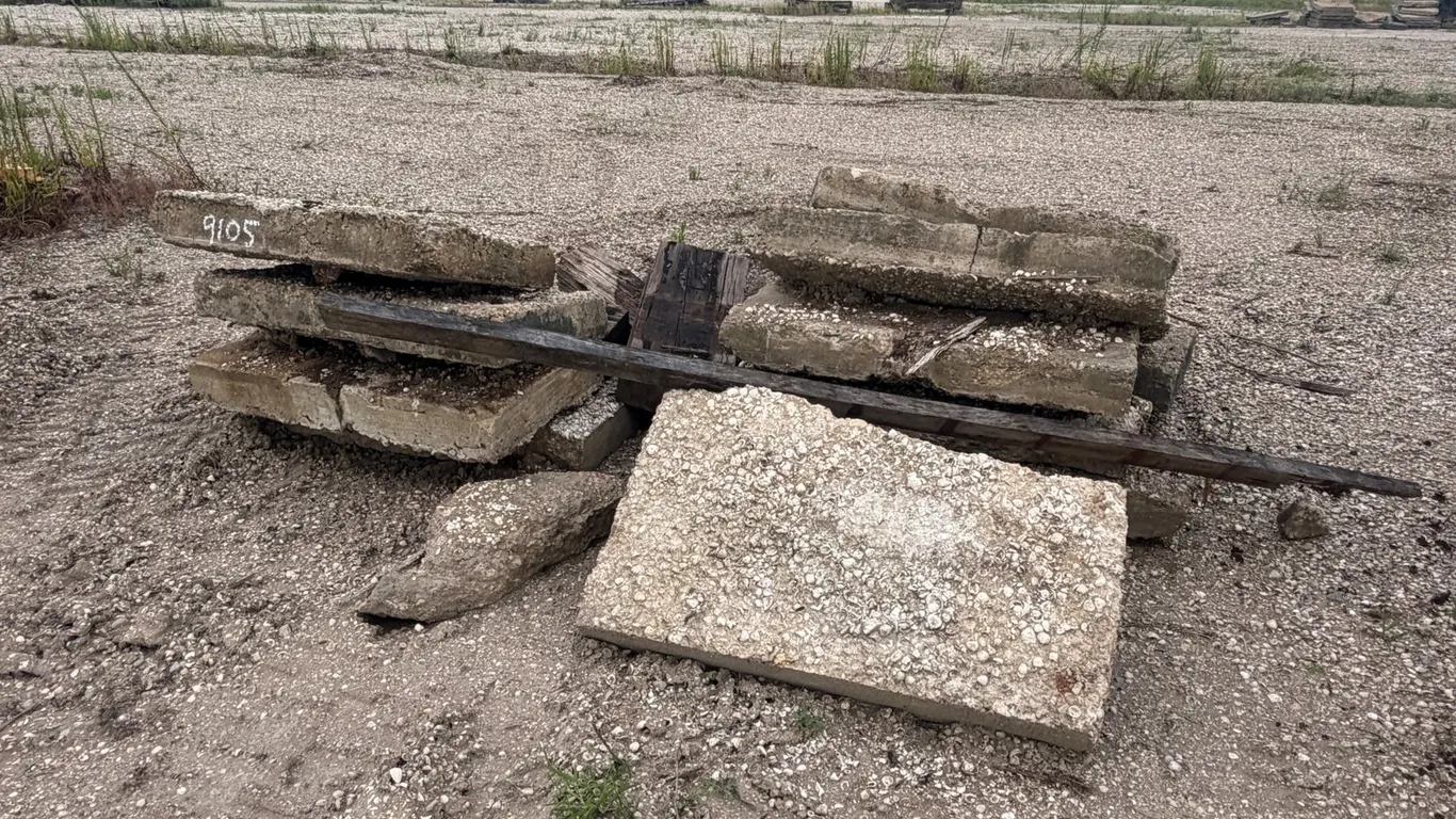 PILE OF RAILROAD TIES AND CONCRETE PAVERS