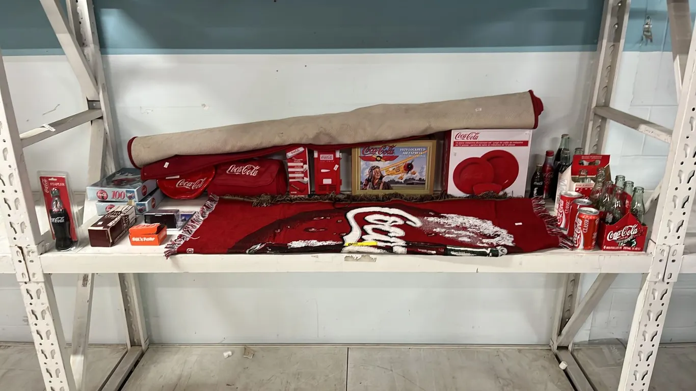 SHELF OF ASSORTED COCA-COLA COLLECTIBLES: THROW BLANKET, AREA RUG, MELAMINE DINNERWARE SET & MORE