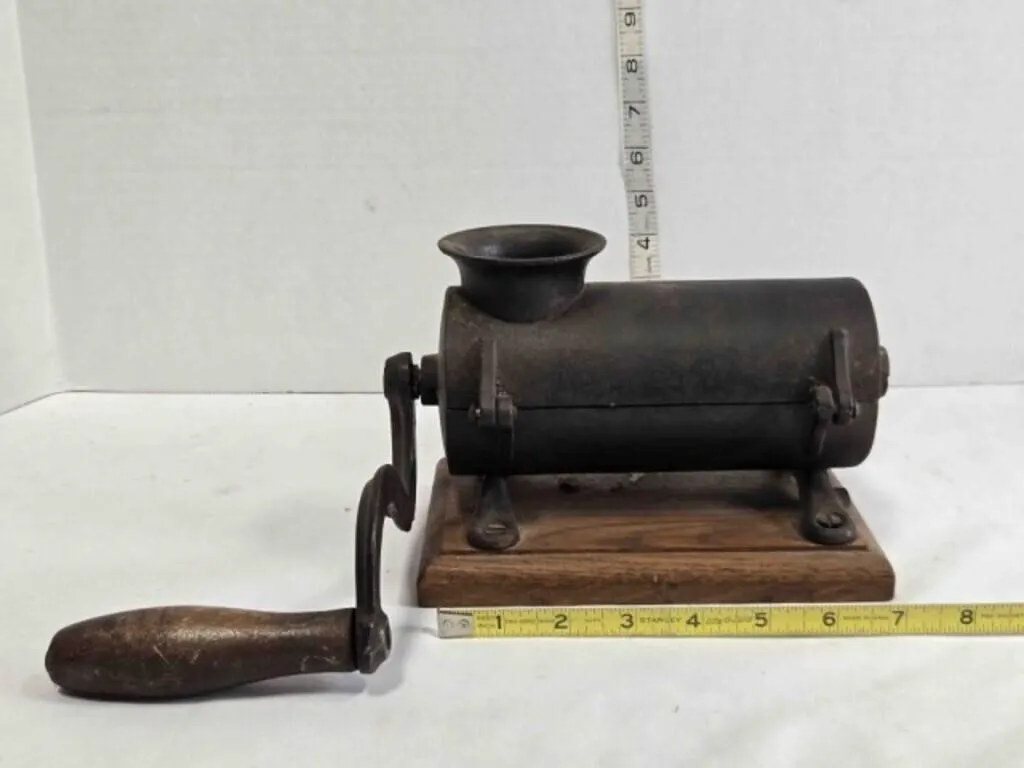 Antique cast iron tobacco shredder on wooden base