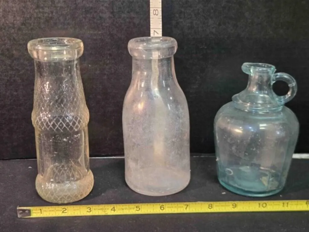 3 clear glass bottles, 2 @ 7" tall, 6" tall