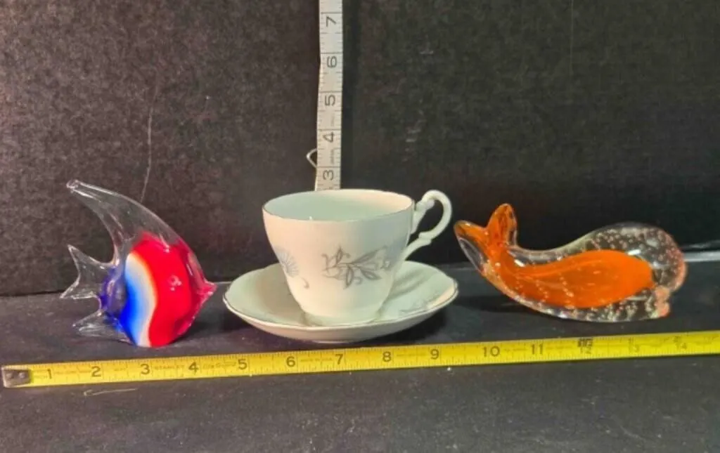 China cup/saucer, glass whale, fish paperweight