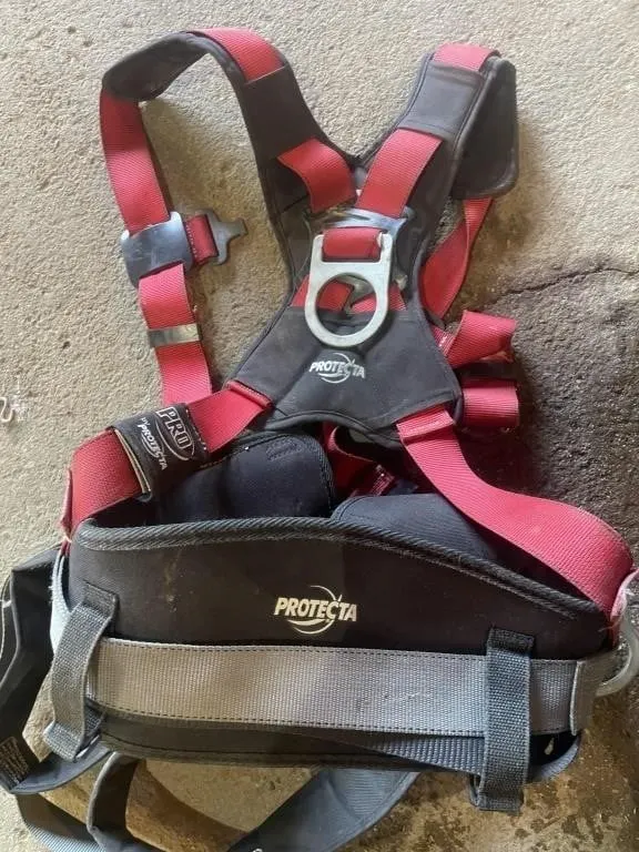 Milk crate full of body safety harnesses, shock