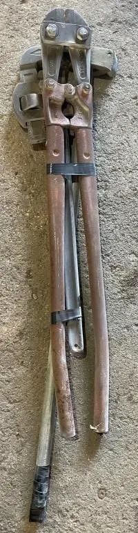 Large pipe wrench, bolt cutters and a hammer.