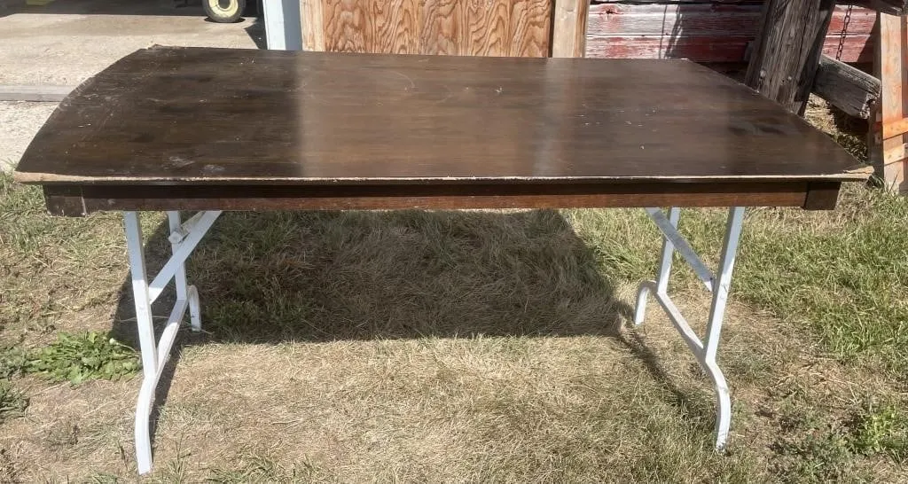Wooden table with folding legs. Approx. 57.5� x