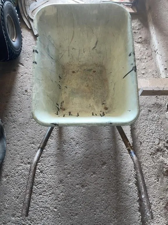 Experienced wheelbarrow with metal frame and a