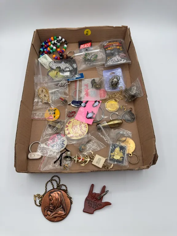 Box lot of miscellaneous jewelry including pins, necklaces, keychains