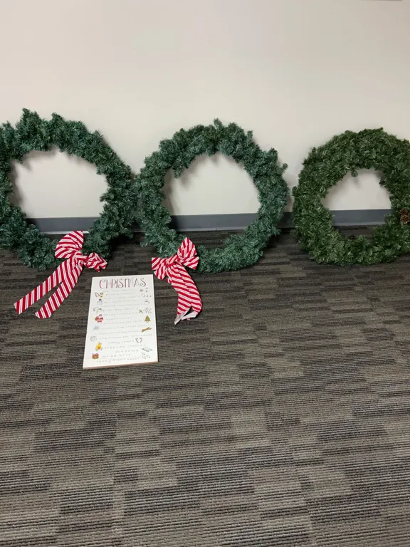 Three Artificial Evergreen Christmas Wreaths with Red & White Bows and Decorative Sign
