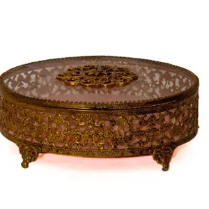 GOLD TONE FILIGREE ORMOLU TRINKET BOX WITH GLASS LID.