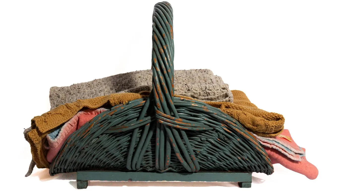 LARGE BLANKET BASKET AND THREE BLANKETS.