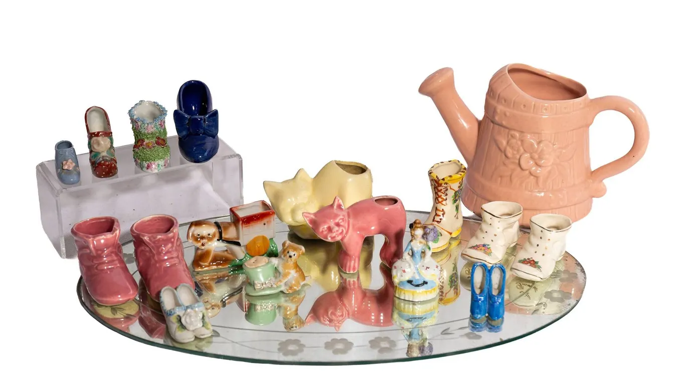 OVAL MIRROR 19.5" H., 11.5" W., CAT FIGURINES, SHOE FIGURINES, PINK CERAMIC WATERING CAN.