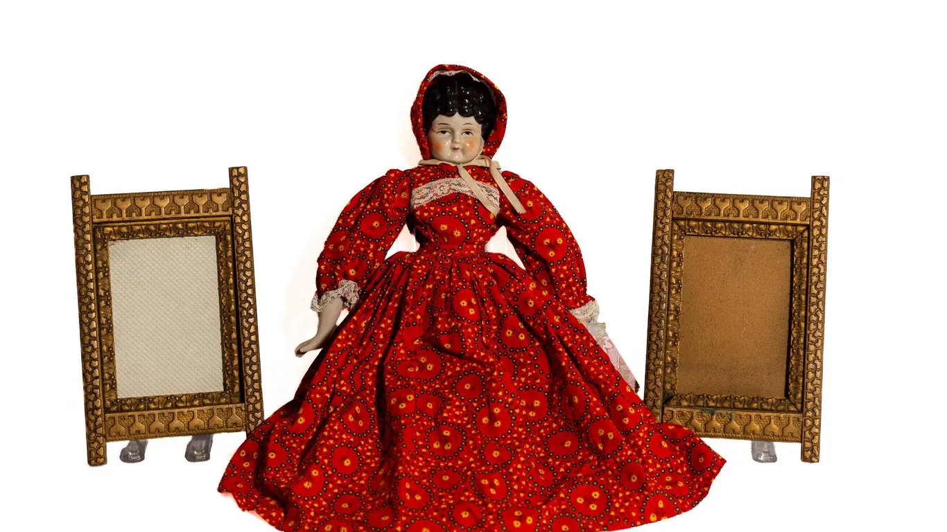 TWO HANGING GOLD FRAME 10" H., 6" W., PAINTED PORCELAIN DOLL.