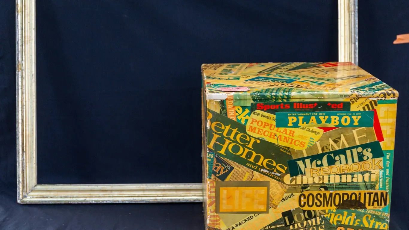 VINTAGE GOLD LEAF FRAME AND DECORATIVE MAGAZINE-COVERED CUBE.