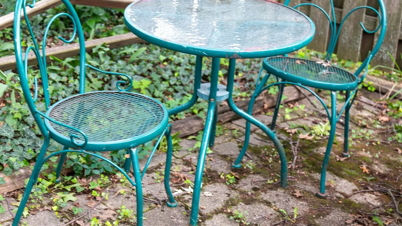 GREEN OUTDOOR BISTRO TABLE WITH GLASS TOP.