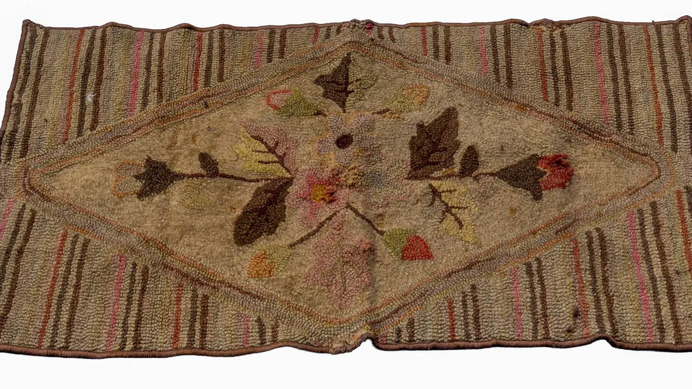 HOOKED RUG WITH FLORAL AND STRIPED PATTERN.