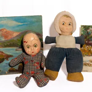 TWO PAINTED CANVAS BOARDS AND TWO VINTAGE DOLLS.