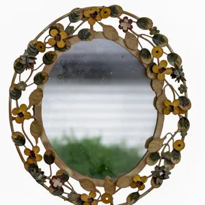 ORNATE FLORAL OVAL MIRROR WITH DECORATIVE FRAME.