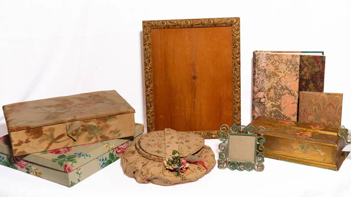 FRAME, BOOKS, SEWING BASKET, AND DECORATIVE BOXES.