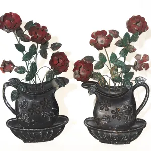 TOLE WALL HANGINGS WITH FLORAL DESIGNS.