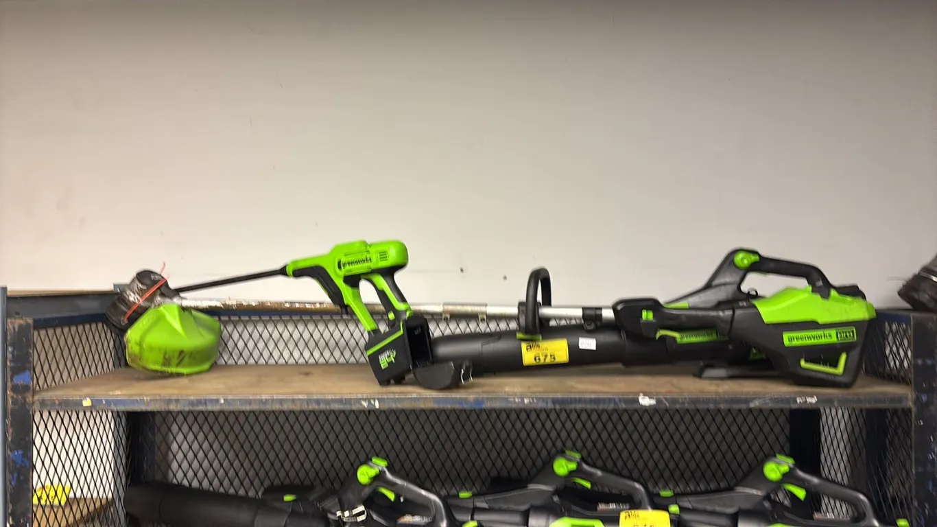 SHELF OF ASSORTED GREEN WORKS CORDLESS TOOLS INCL. PRO TRIMMER, PRO BLOWER AND PRESSURE WASHER