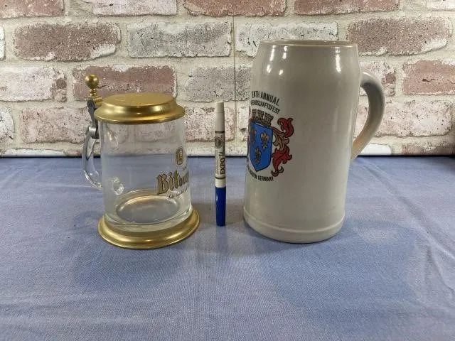(2 PCS) GERMAN STEINS - 1 CERAMIC, 1 GLASS & BRASS