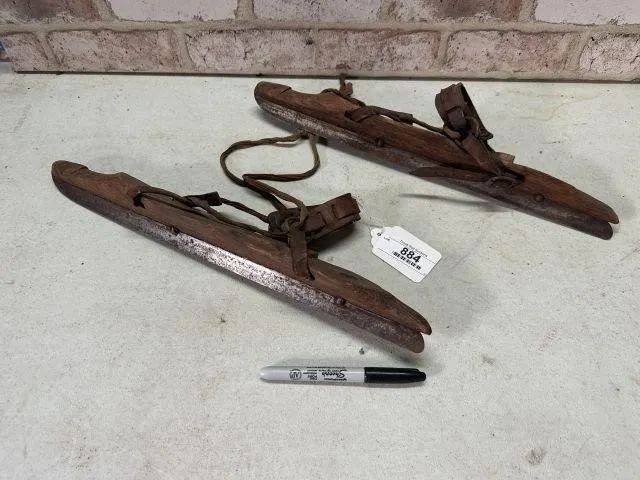PAIR OF ANTIQUE WOODEN STRAP ON ICE SKATES WITH