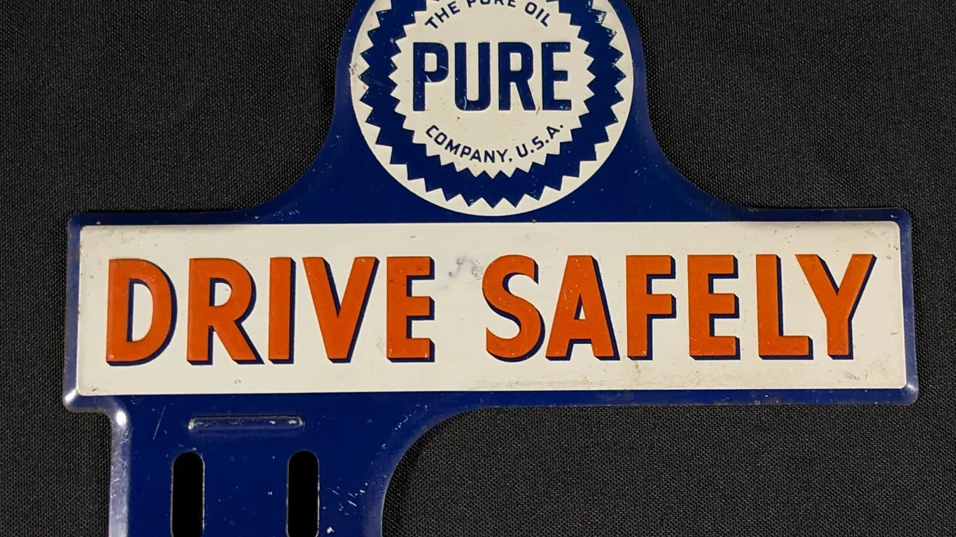 EMBOSSED TIN LICENSE PLATE SIGN THE PURE OIL COMPANY DRIVE SAFELY