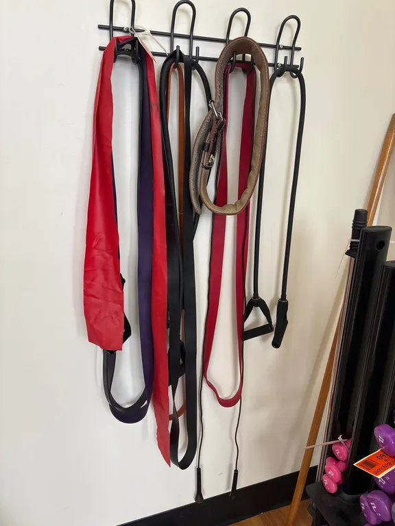 Mounted Rack With Assorted Exercise Resistance Training Equipment