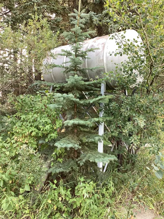 Metal Water Storage Tank on Elevated Support Frame