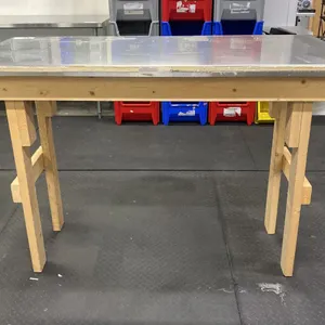 WOOD FRAME TABLE WITH STAINLESS STEEL TOP COVER APPROX 58"L X 26"D X 40"H
