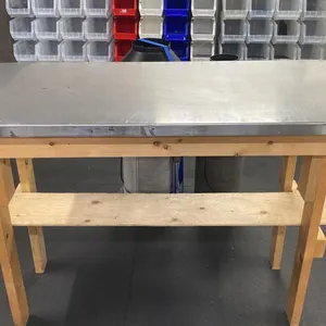 WOOD FRAME TABLE WITH STAINLESS STEEL TOP COVER APPROX 58"L X 26"D X 40"H