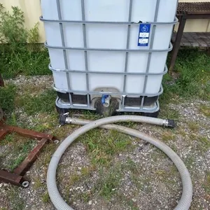 1000 liter tank with metal cage & hose. 37 1/2" l