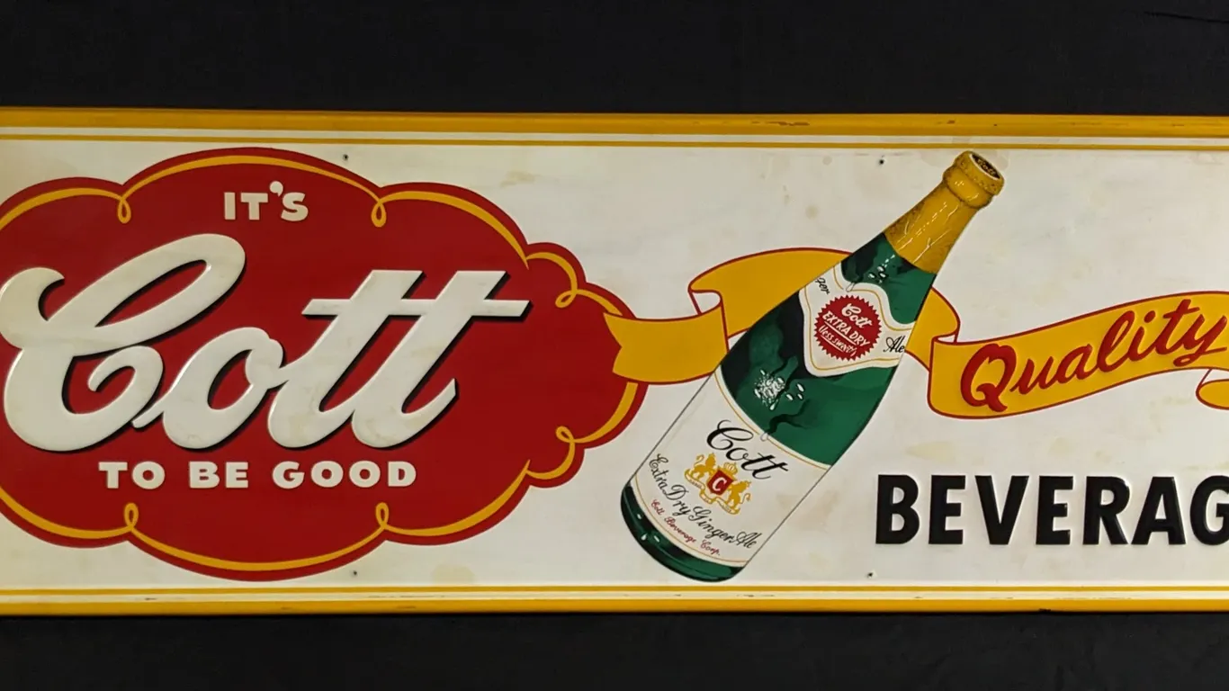 EMBOSSED TIN SIGN IT'S COTT TO BE GOOD GINGER ALE