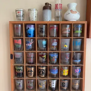 39 Shot Glasses with Wooden Display Rack, Stoneware Jug, and Ceramic Vase