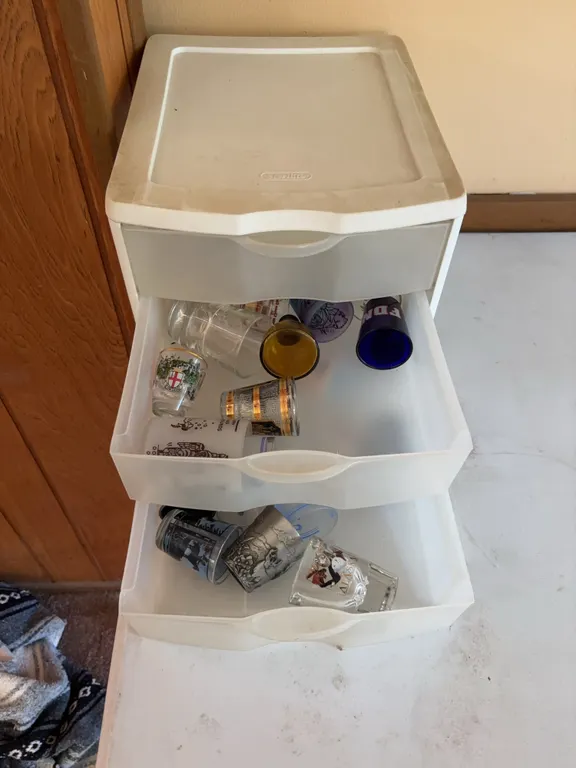 Sterilite 3-Drawer Storage Cabinet with Assorted Souvenir Glasses and Mugs