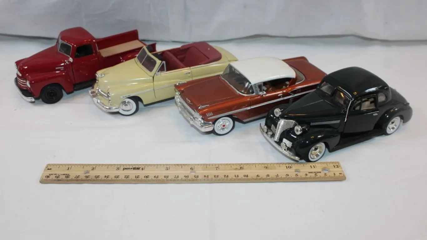 Four 1:24 Scale Diecast Cars: 1939 Chevy Coupe, Classic Metal Works '50s Chevy Impala, Classic Metal Works Mercury Convertible, and Maisto 1950 Chevy